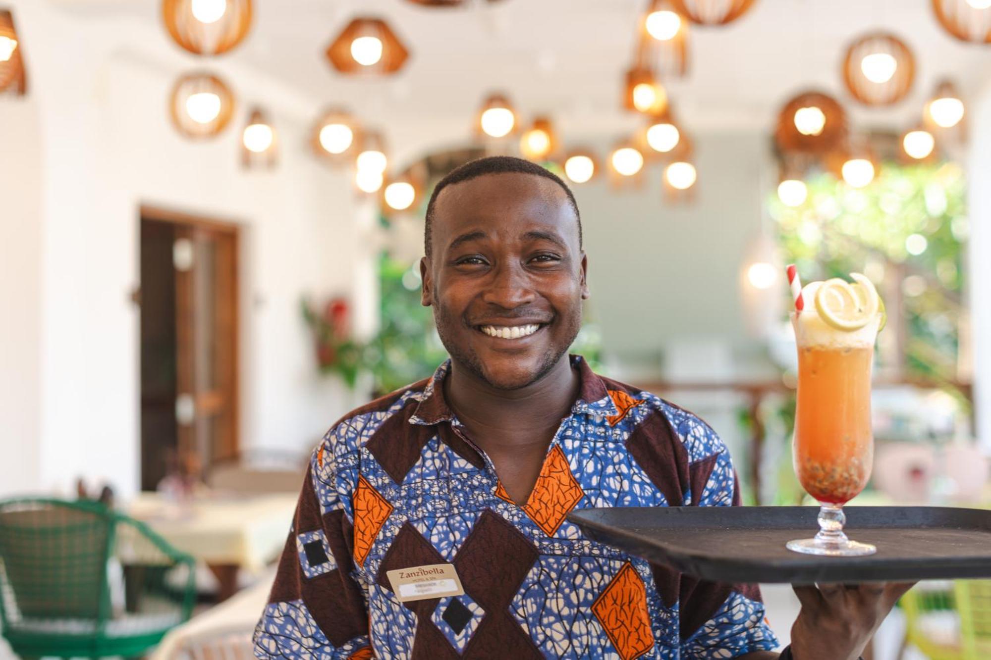 Zanzibella Hotel & Spa Кивенгва Экстерьер фото A waiter at the Serena Hotel in Kampala, Uganda